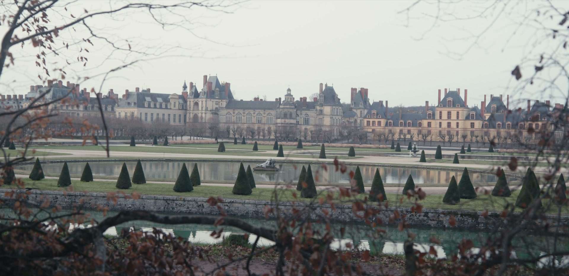 Le château de Fontainebleau vu depuis le parc, une joggeuse traverse le cadre